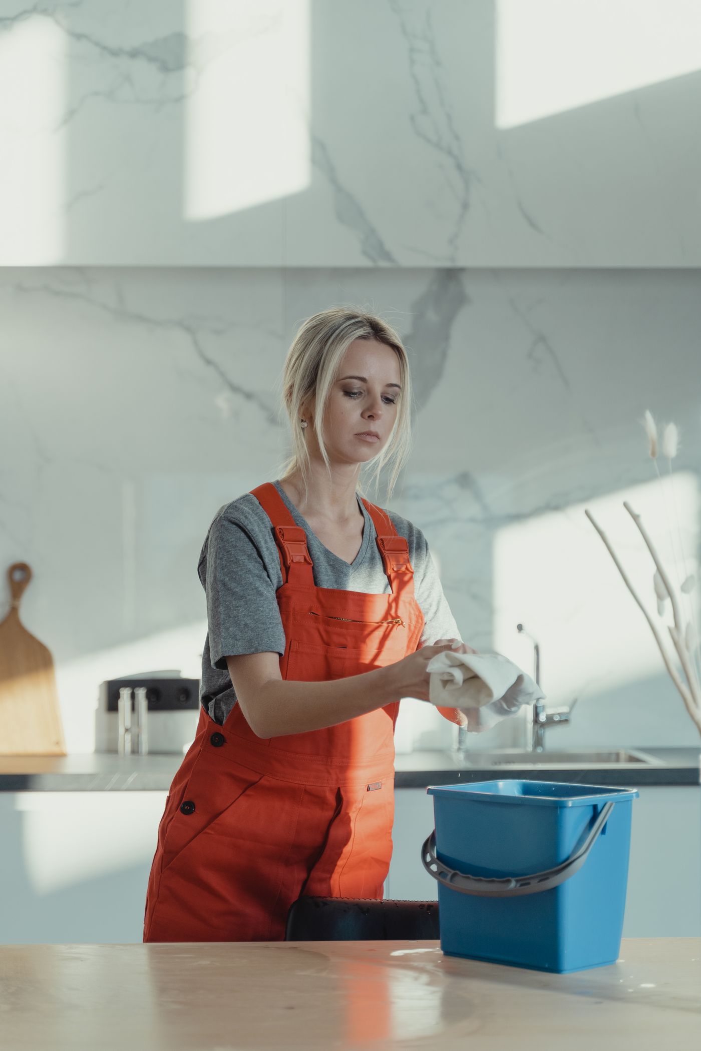 A house cleaner running her business with TidyBee on her phone